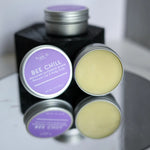 BEE CHILL Beeswax Lip Balm containers open and stacked.