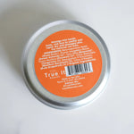 Load image into Gallery viewer, Close-up of the back of a container of Bee Happy beeswax balm highlighting the ingredients
