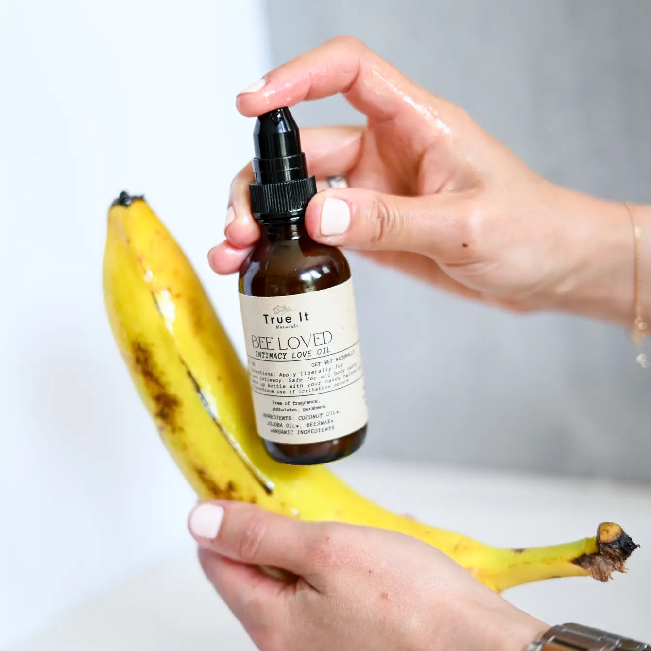 True It Naturals Bee Loved natural beeswax massage oil applied on a banana as a demo.