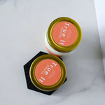 Load image into Gallery viewer, Two jars with gold lids and coral labels on a white background
