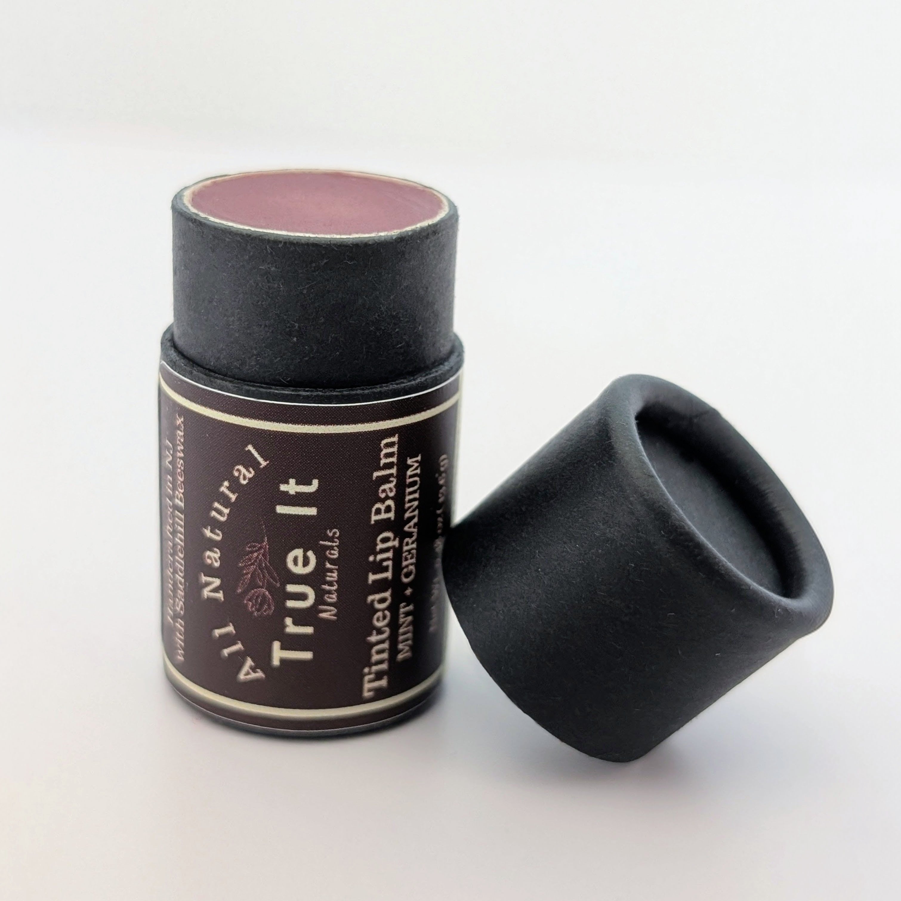 True It Naturals Tinted Lip Balm with the cap off showing off the natural tint