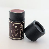 True It Naturals Tinted Lip Balm with the cap off showing off the natural tint