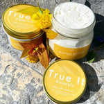 Load image into Gallery viewer, True It Naturals Mango Butter with the Large (4oz) jar lid off to show the butter texture and Small jar (2oz) next to it.
