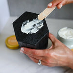 Load image into Gallery viewer, rue It Naturals Lavender Mango Butter Body Butter with cap off. Scooping some of the body butter and showing the texture when applying it.
